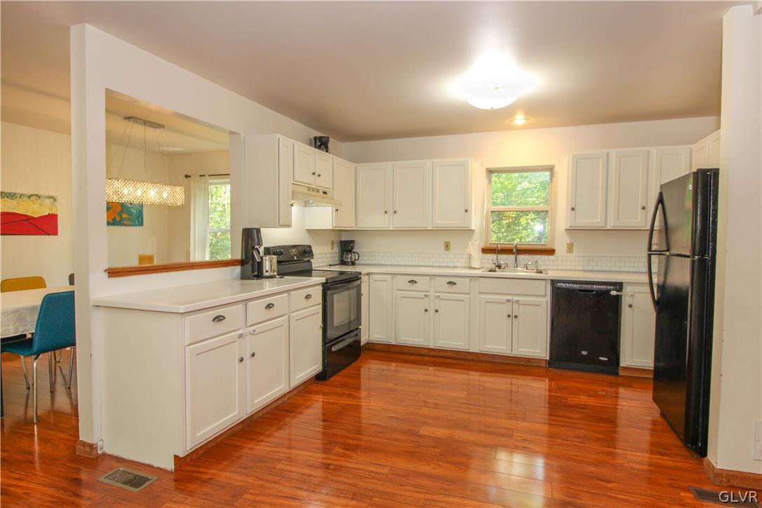 4219 Winchester Way Bushkill, PA 18324 - Photo 12 of 49 a kitchen with granite countertop a refrigerator stove top oven and sink
