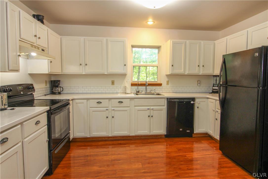 4219 Winchester Way Bushkill, PA 18324 - Photo 13 of 49 a kitchen with a sink stove and refrigerator