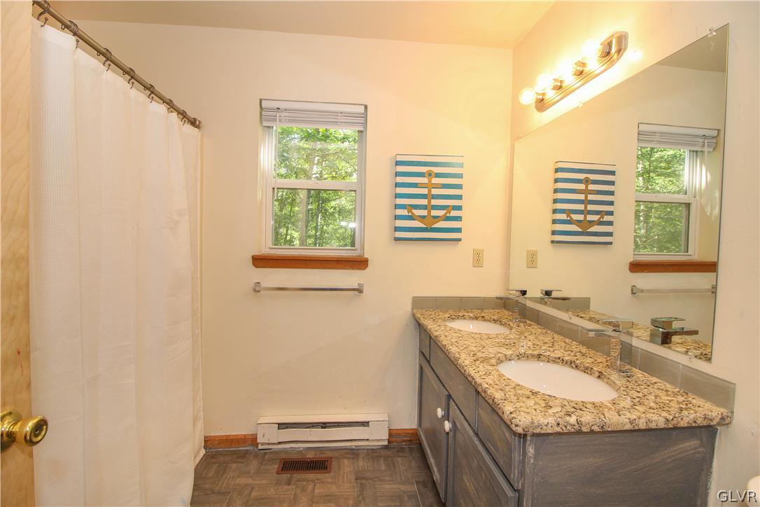 4219 Winchester Way Bushkill, PA 18324 - Photo 17 of 49 a bathroom with a granite countertop sink and a tub