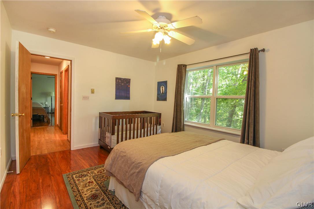 4219 Winchester Way Bushkill, PA 18324 - Photo 18 of 49 a bedroom with a bed and a chandelier