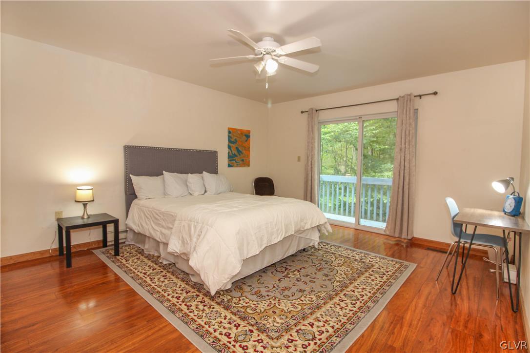 4219 Winchester Way Bushkill, PA 18324 - Photo 19 of 49 a bedroom with a bed and a table