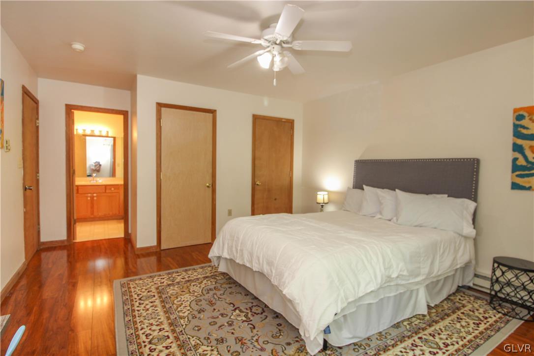 4219 Winchester Way Bushkill, PA 18324 - Photo 20 of 49 a bedroom with a bed and wooden floor