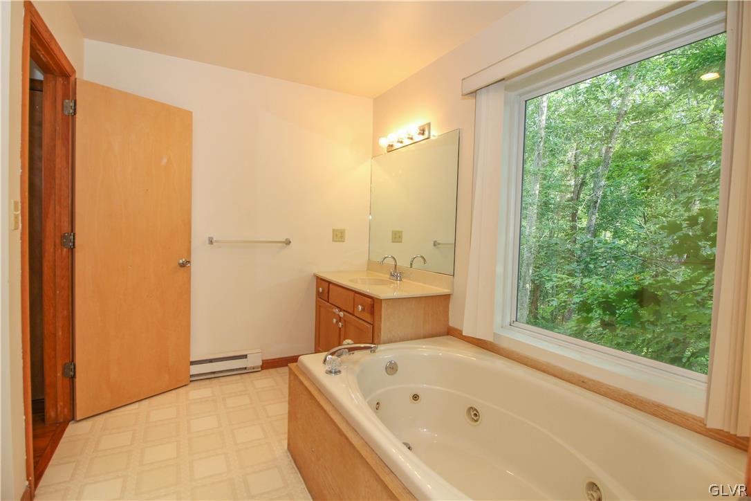 4219 Winchester Way Bushkill, PA 18324 - Photo 21 of 49 a bathroom with a bathtub and shower