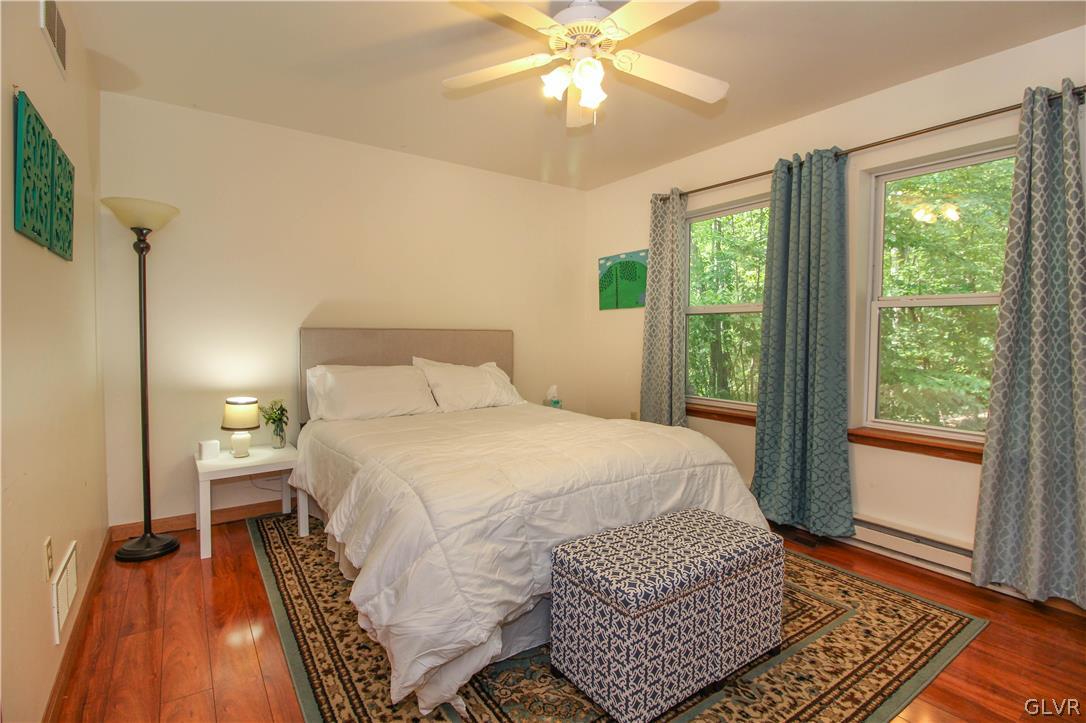 4219 Winchester Way Bushkill, PA 18324 - Photo 25 of 49 a bedroom with a bed and wooden floor