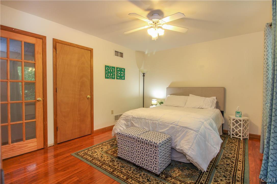 4219 Winchester Way Bushkill, PA 18324 - Photo 26 of 49 a bedroom with a bed and wooden floor