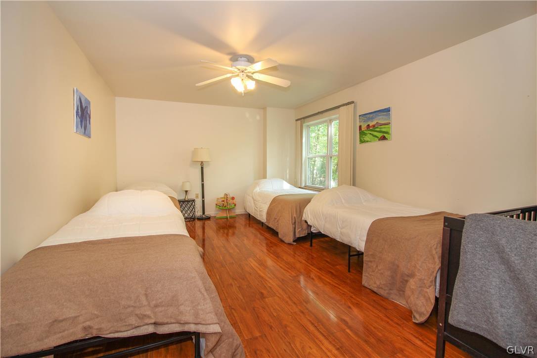 4219 Winchester Way Bushkill, PA 18324 - Photo 29 of 49 a bedroom with two beds and lamps