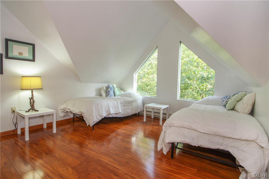 4219 Winchester Way Bushkill, PA 18324 - Photo 31 of 49 a bedroom with a bed and wooden floor