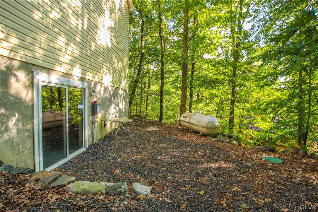 4219 Winchester Way Bushkill, PA 18324 - Photo 38 of 49 a backyard of a house with lots of green space