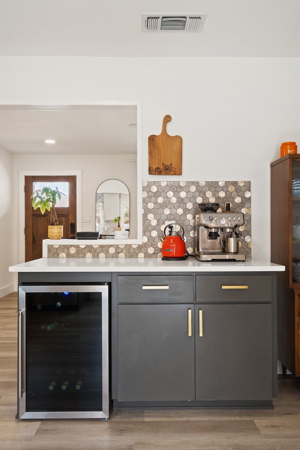 4705 Old Castle Road Austin, TX 78745 - Photo 13 of 32 A neaby dry bar includes a wine fridge and statement mosaic tile backsplash.