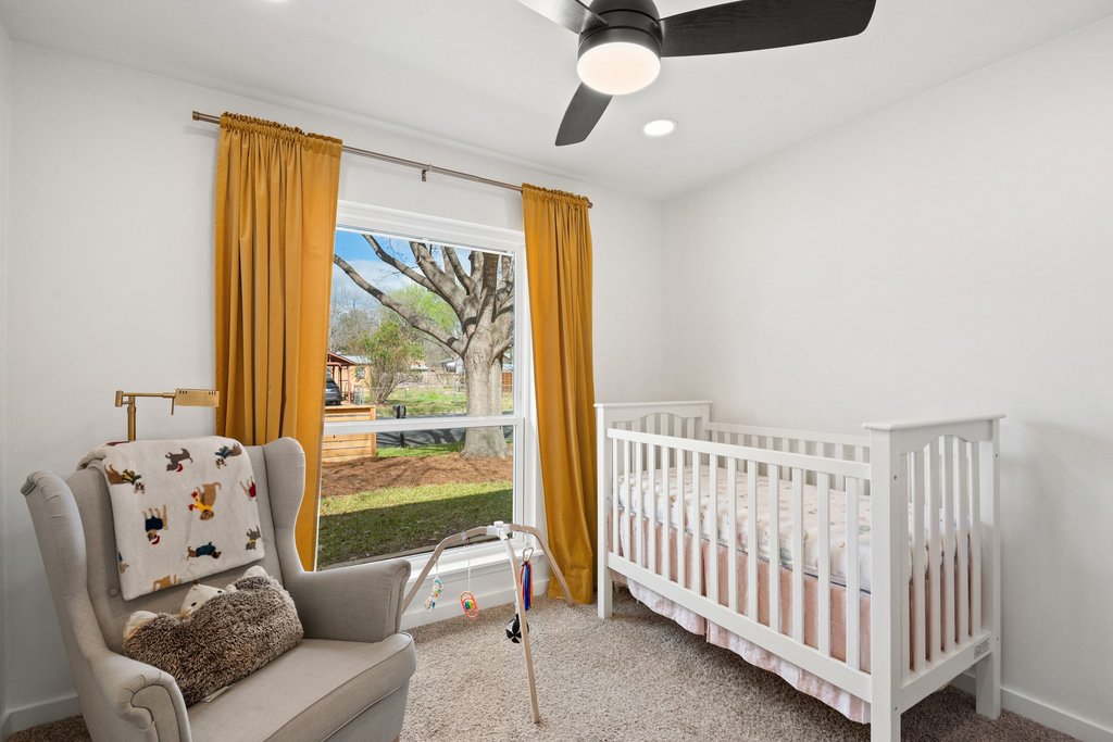 4705 Old Castle Road Austin, TX 78745 - Photo 23 of 32 The first of the 2 secondary bedrooms has an oversized window that allows natural light to fill the space.The second of the secondary room also has an oversized and can be configured as an office or hobby room.