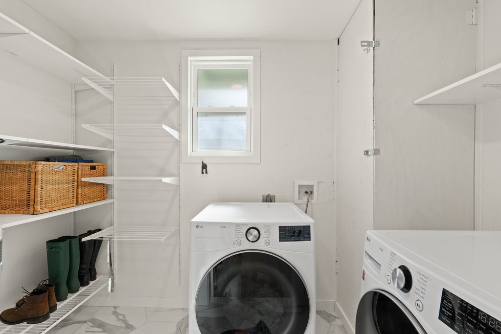 4705 Old Castle Road Austin, TX 78745 - Photo 27 of 32 A dedicated laundry room has extra shelving and space to keep supplies, rain boots, and everyday storage neatly organized.