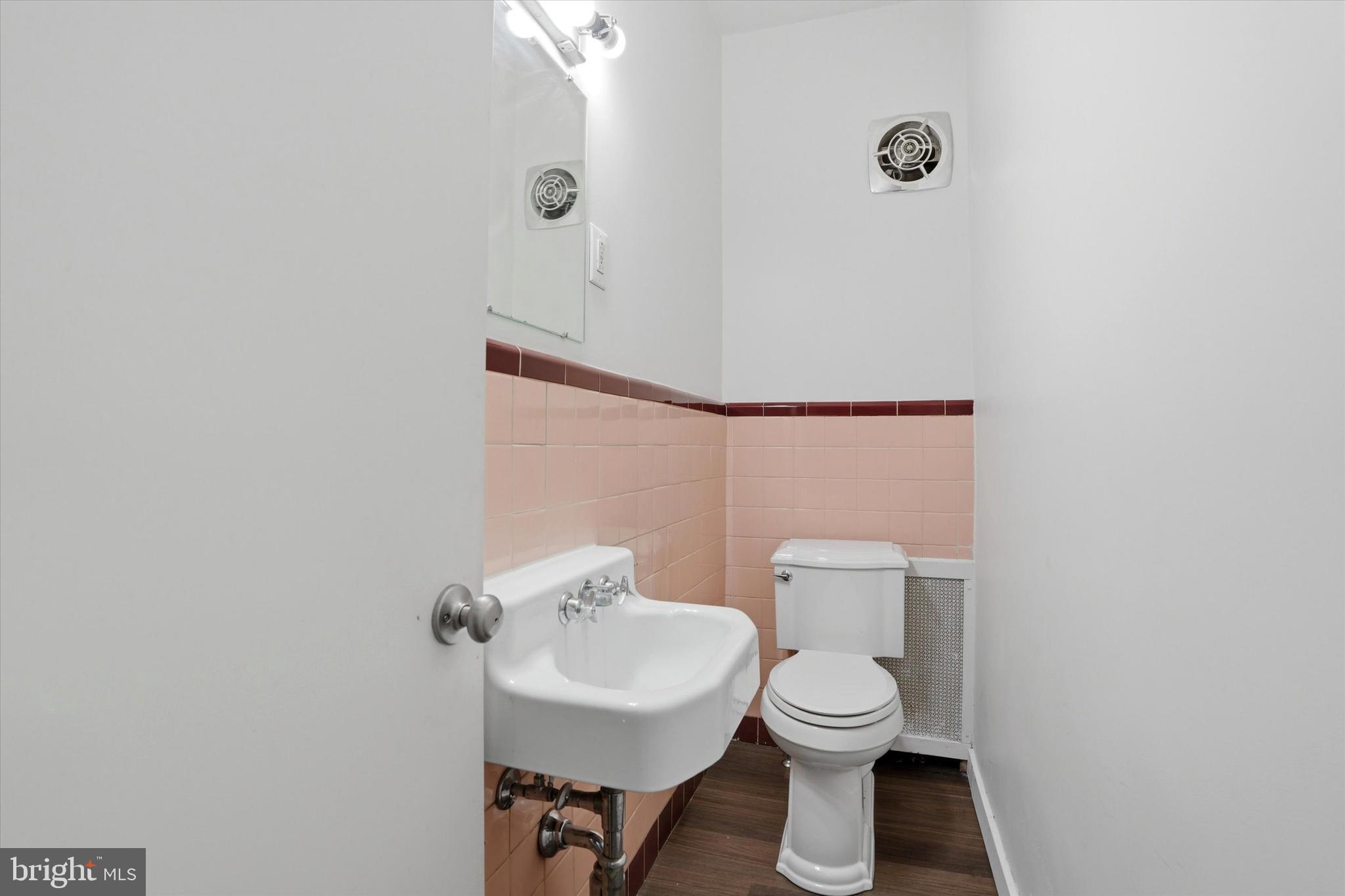 112 North 11th Street, Unit 1 Reading, PA 19601 - Photo 13 of 17 a bathroom with a toilet sink and mirror