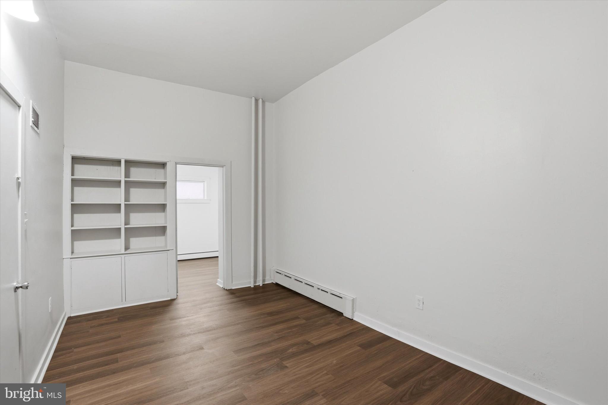112 North 11th Street, Unit 1 Reading, PA 19601 - Photo 4 of 17 an empty room with wooden floor closet and windows