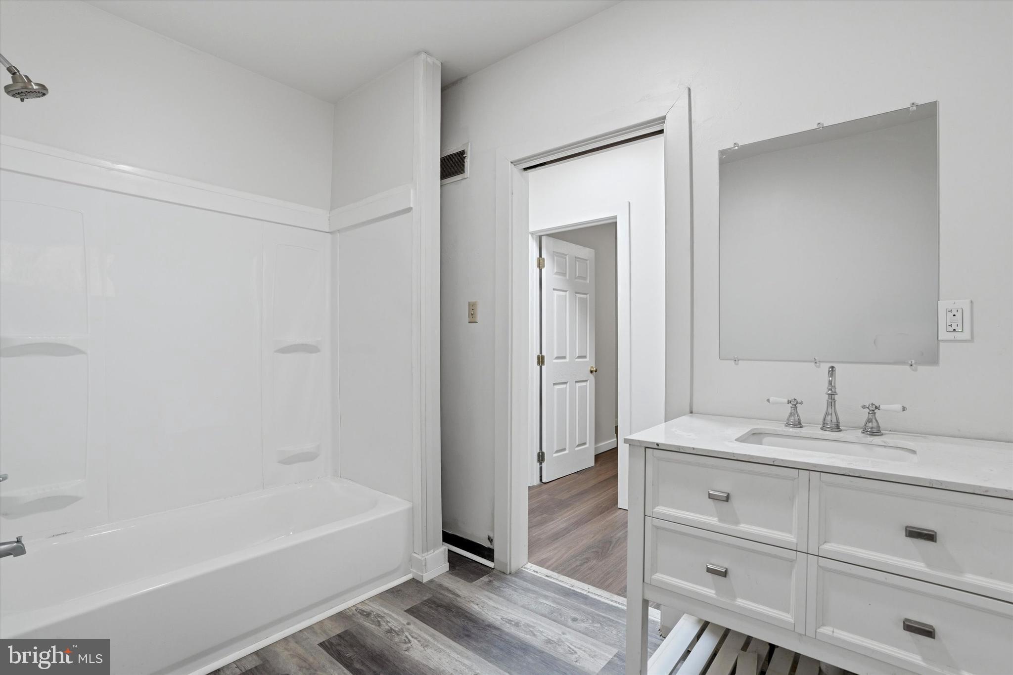 112 North 11th Street, Unit 1 Reading, PA 19601 - Photo 9 of 17 a bathroom with a tub shower vanity and a sink