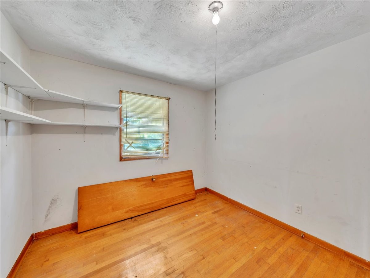 707 Molino Road Taft, TN 38488 - Photo 20 of 28 a blue bed sitting in a room next to a window