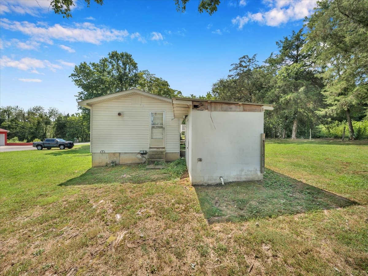 707 Molino Road Taft, TN 38488 - Photo 3 of 28 a view of a white house with a yard