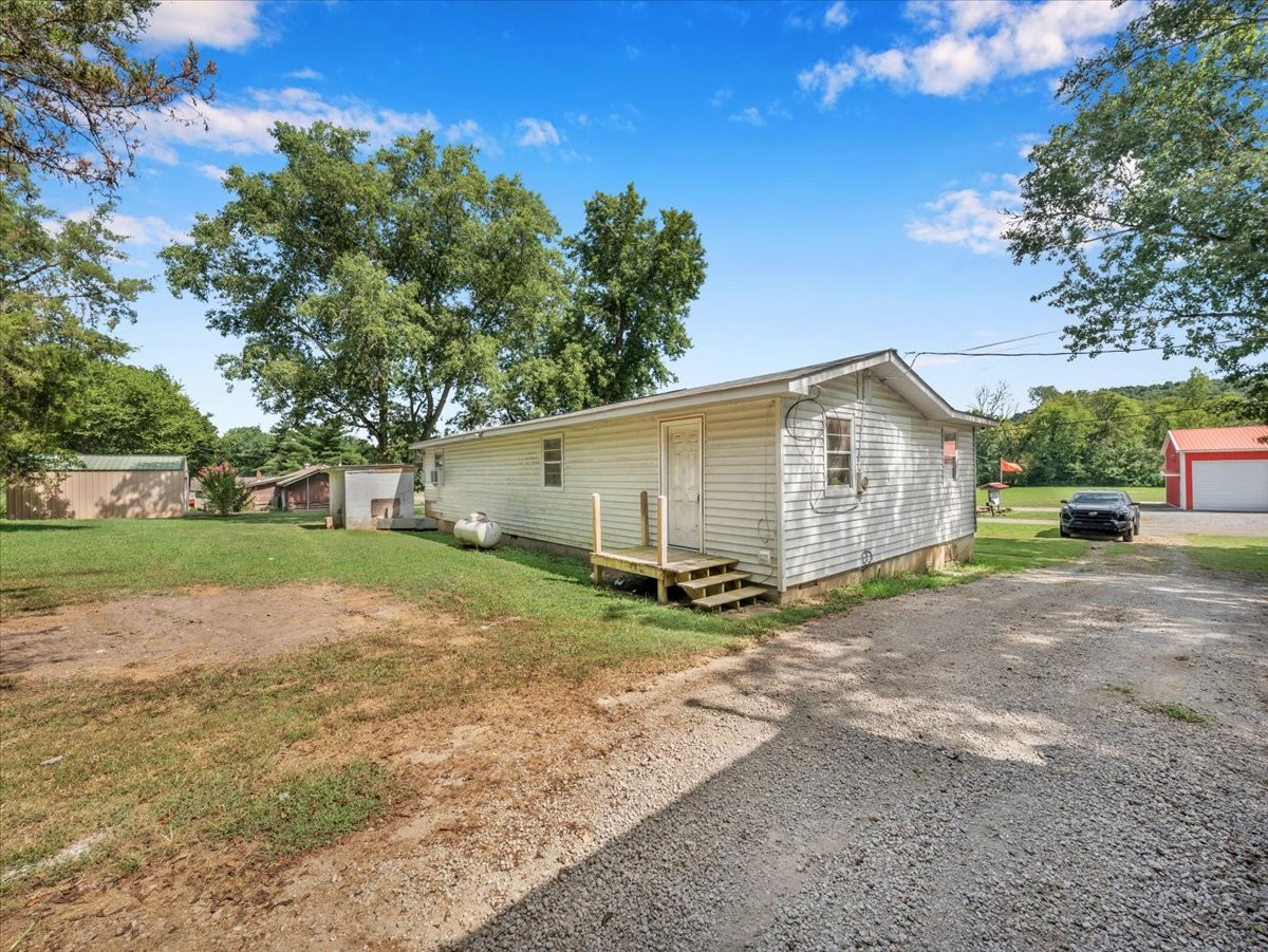 707 Molino Road Taft, TN 38488 - Photo 6 of 28 a view of a house with backyard and trees
