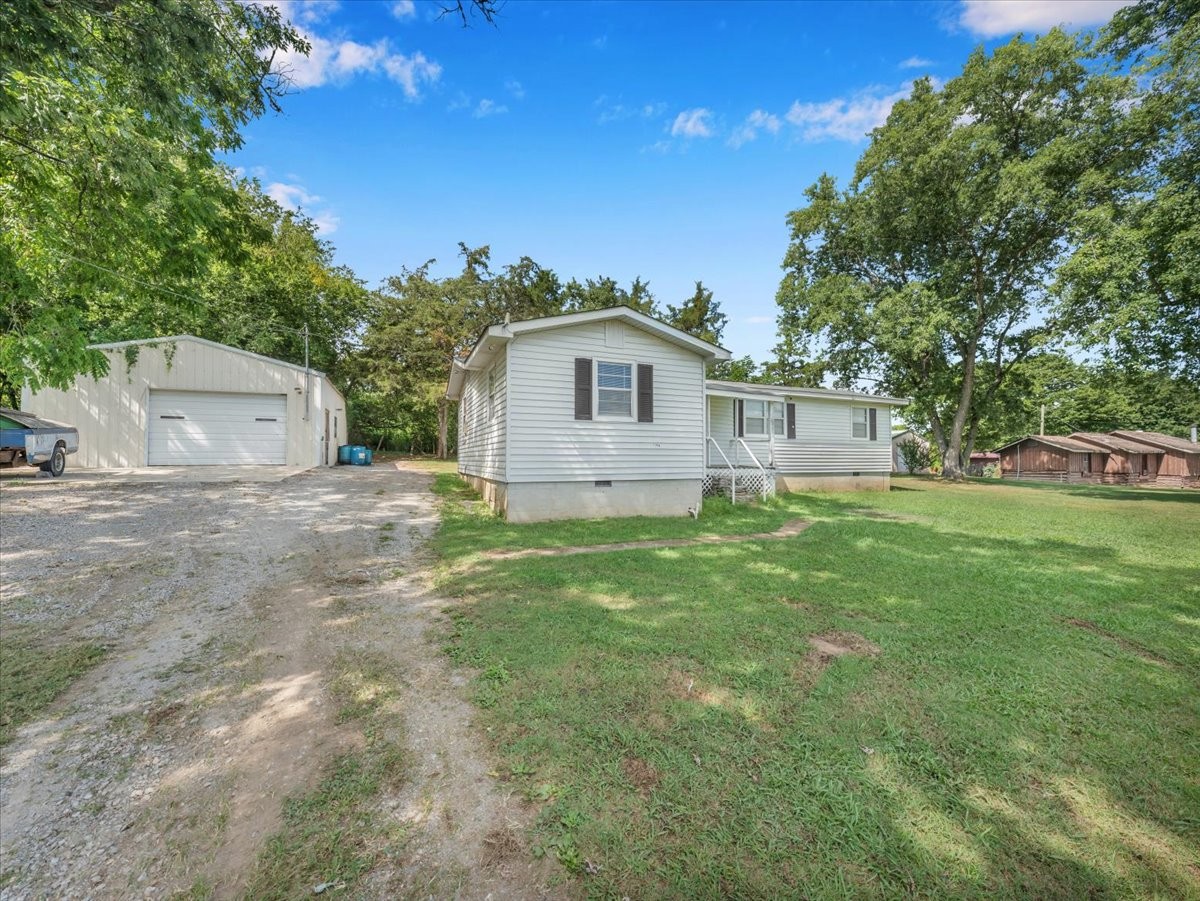 707 Molino Road Taft, TN 38488 - Photo 8 of 28 a front view of a house with a garden