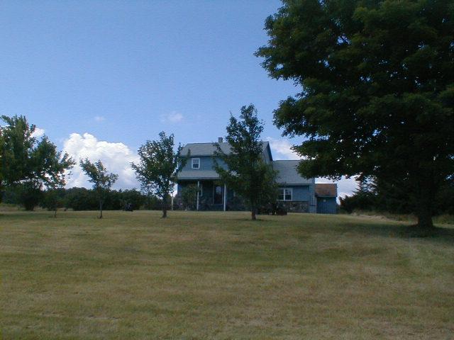 1410 Peru Road Windsor, MA 01270 - Photo 1 of 12 a front view of a house with a garden