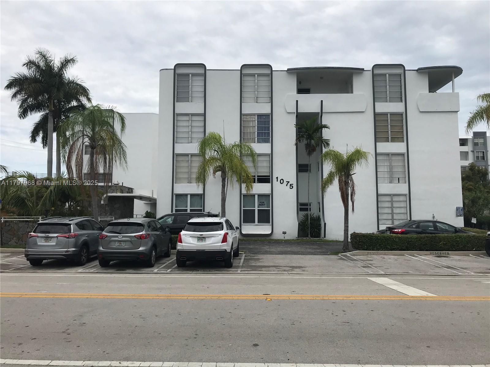 1075 93rd Street, Unit 404 Bay Harbor Islands, FL 33154 - Photo 1 of 14 a car parked in front of a building