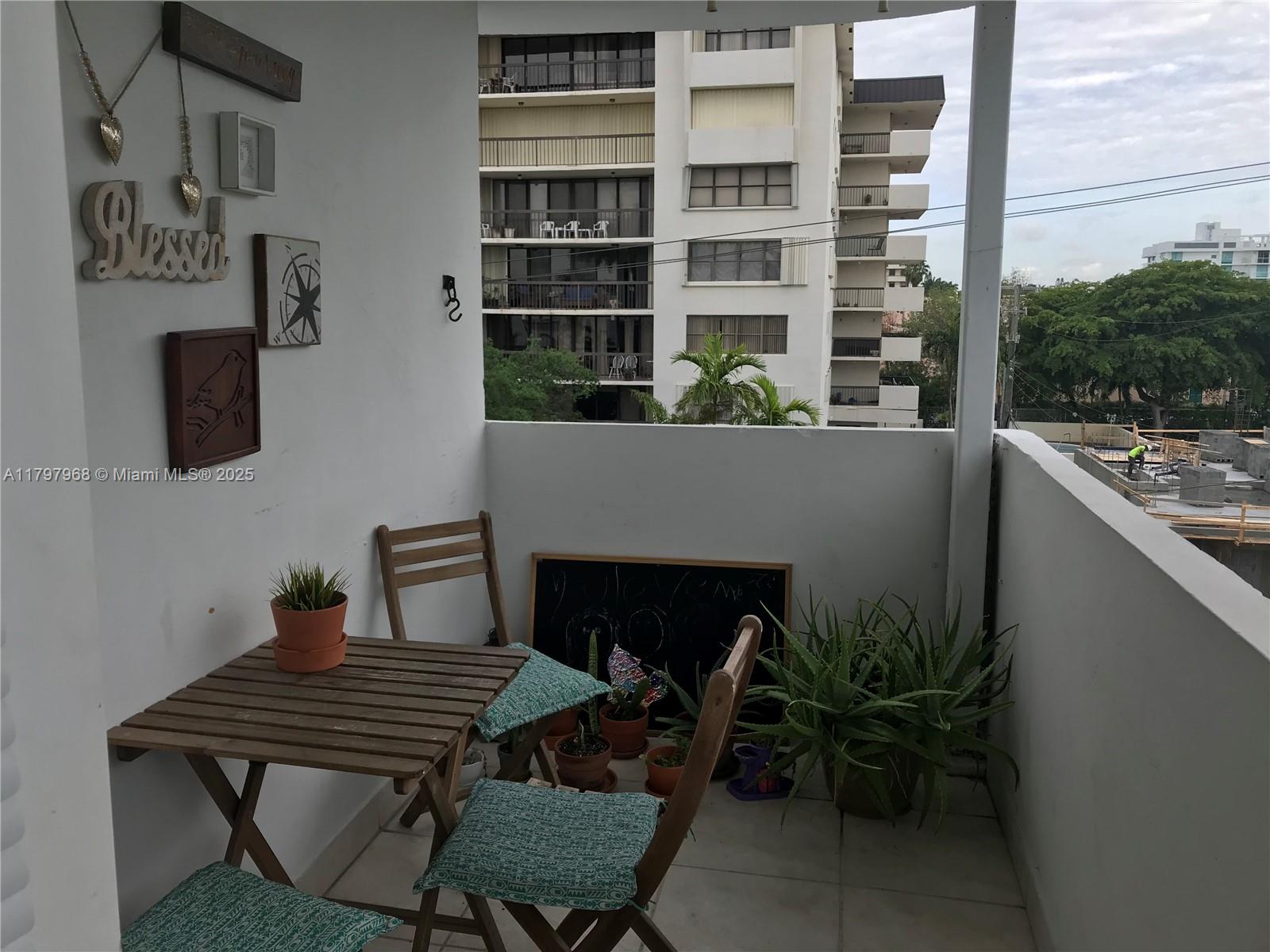 1075 93rd Street, Unit 404 Bay Harbor Islands, FL 33154 - Photo 12 of 14 a living room with furniture a fireplace and a potted plant