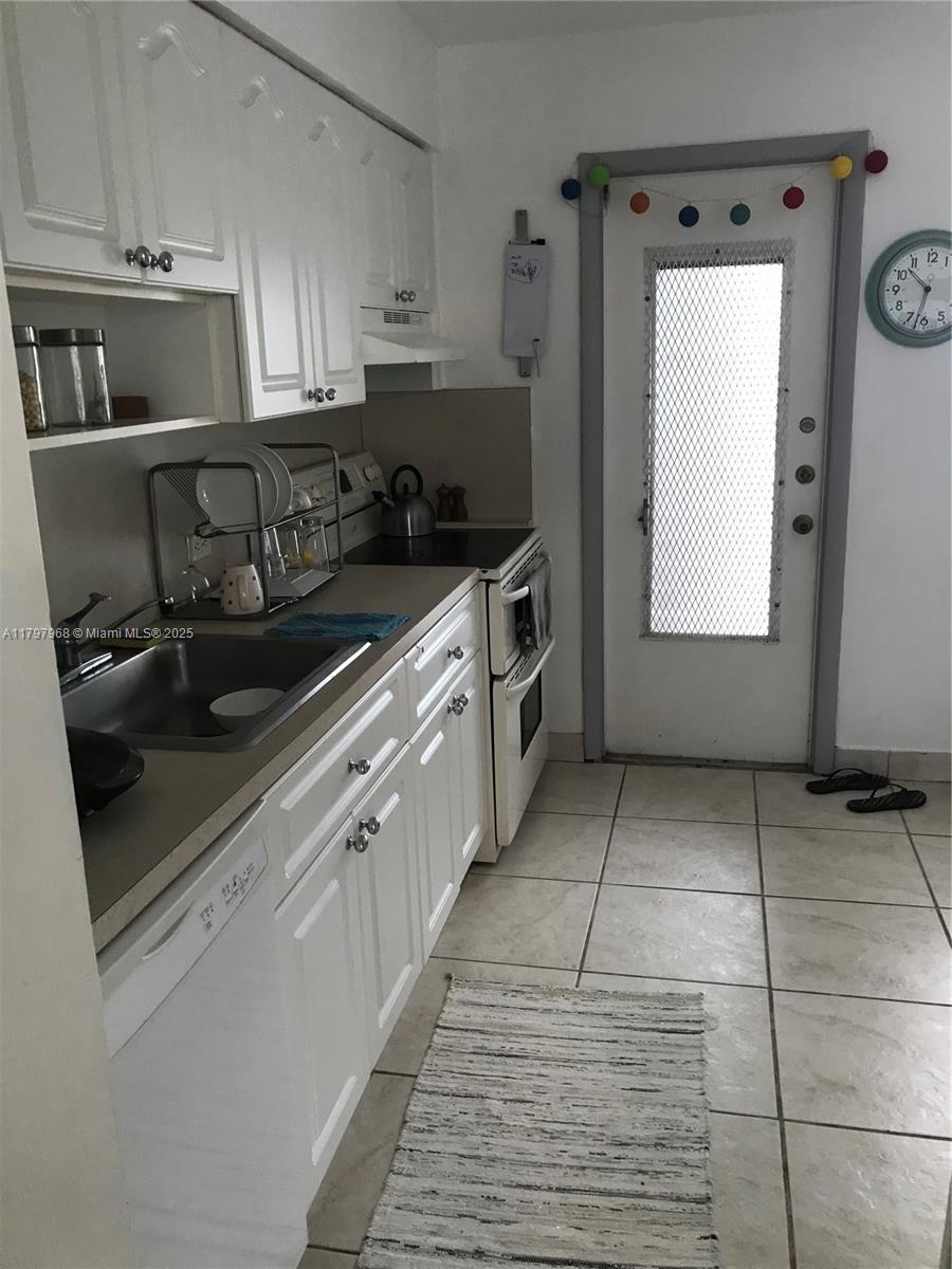 1075 93rd Street, Unit 404 Bay Harbor Islands, FL 33154 - Photo 14 of 14 a kitchen with a sink and cabinets