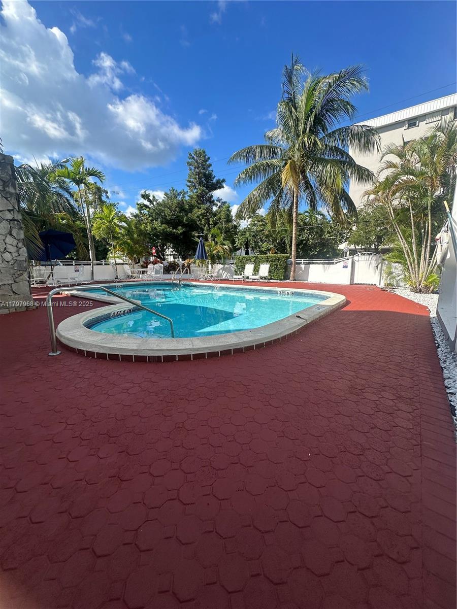 1075 93rd Street, Unit 404 Bay Harbor Islands, FL 33154 - Photo 9 of 14 front view of a house with a yard