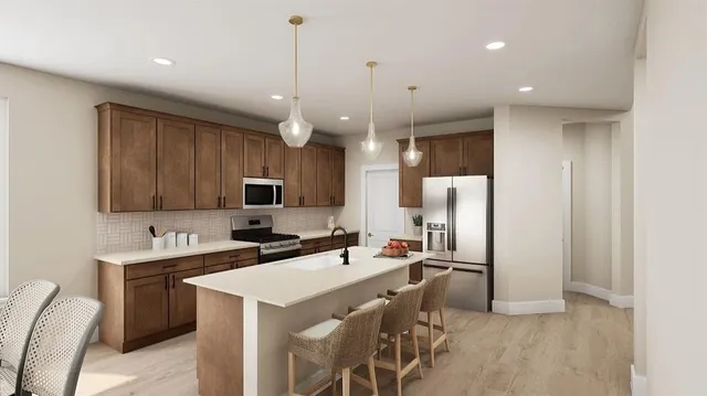 a kitchen with a sink a counter space appliances and cabinets