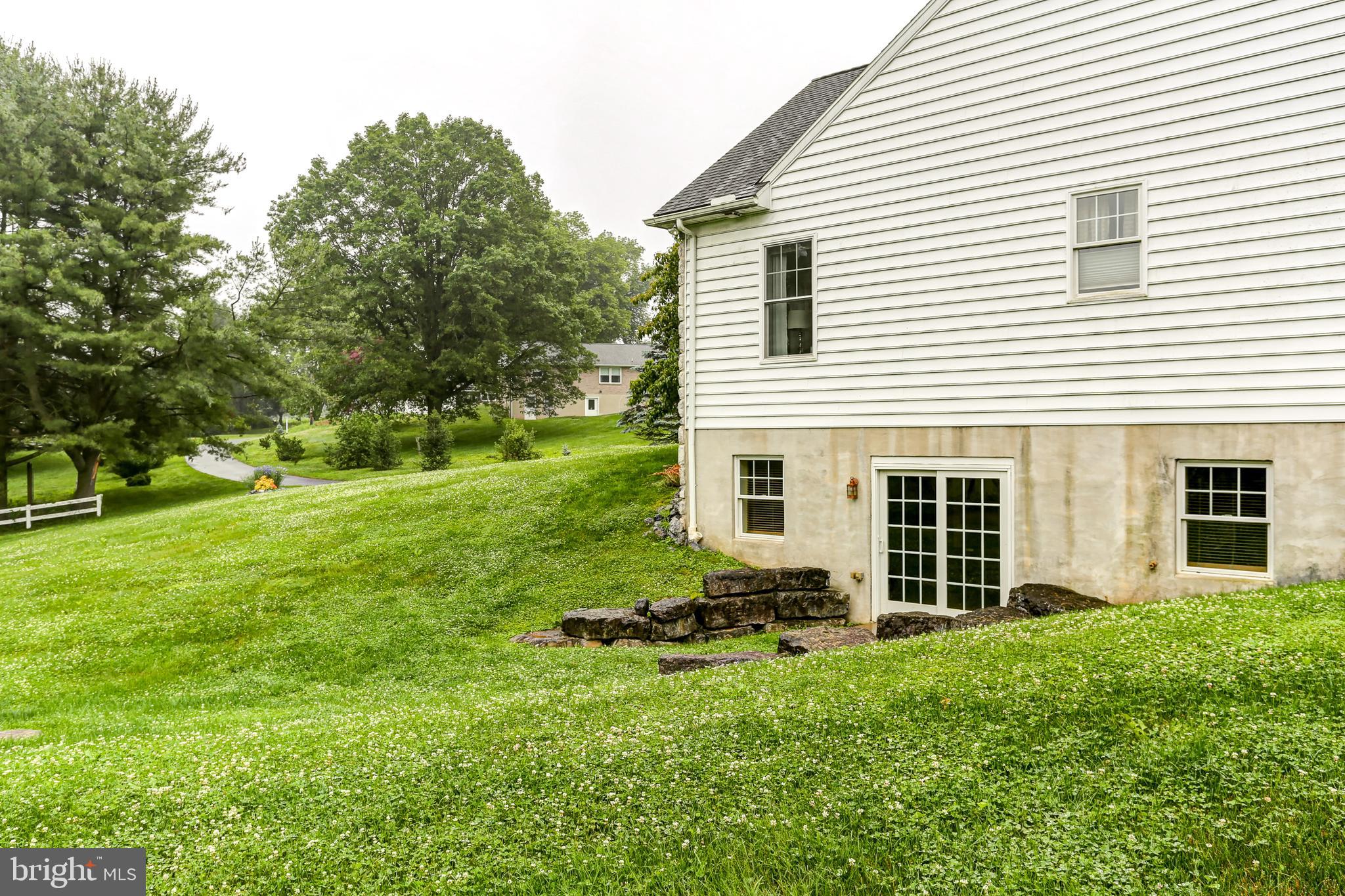10 Elser Hill Road Lititz, PA 17543 - Photo 56 of 63 a backyard of a house with plants and large tree