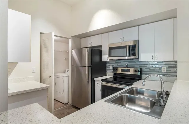 a kitchen with a refrigerator sink and microwave