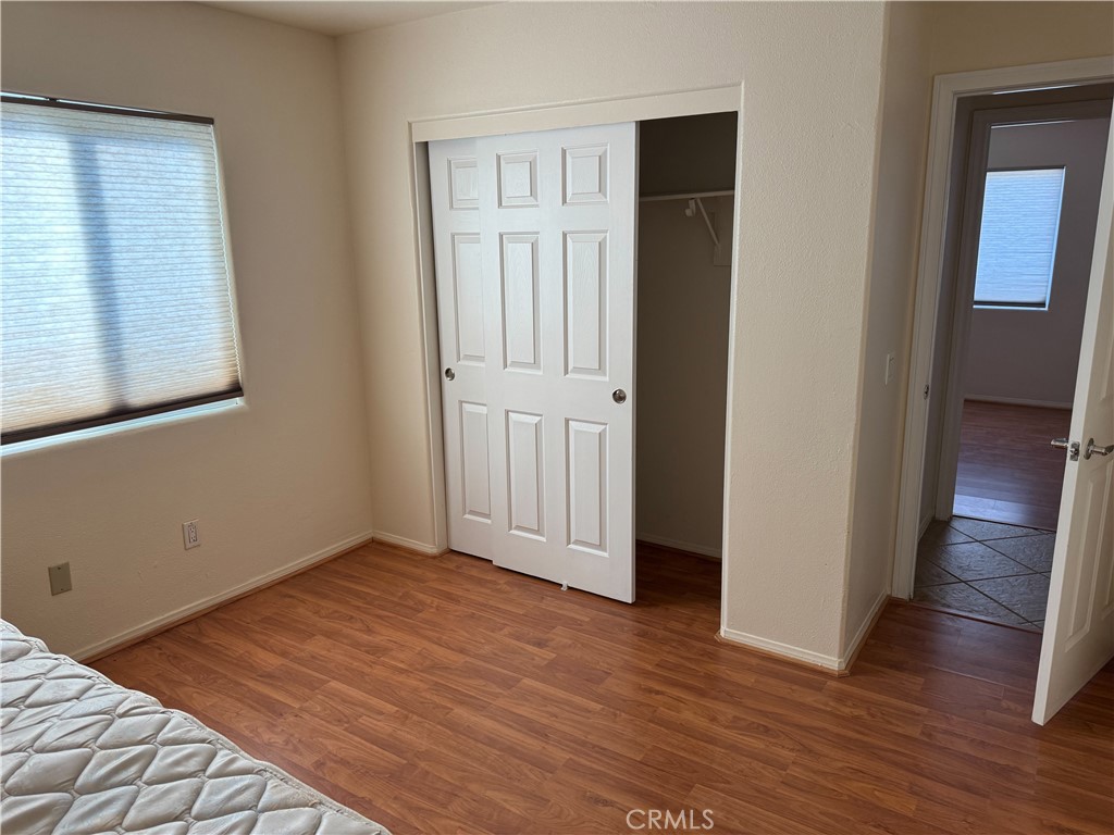 1390 Curtis Avenue Thermal, CA 92274 - Photo 6 of 11 an empty room with wooden floor and closet