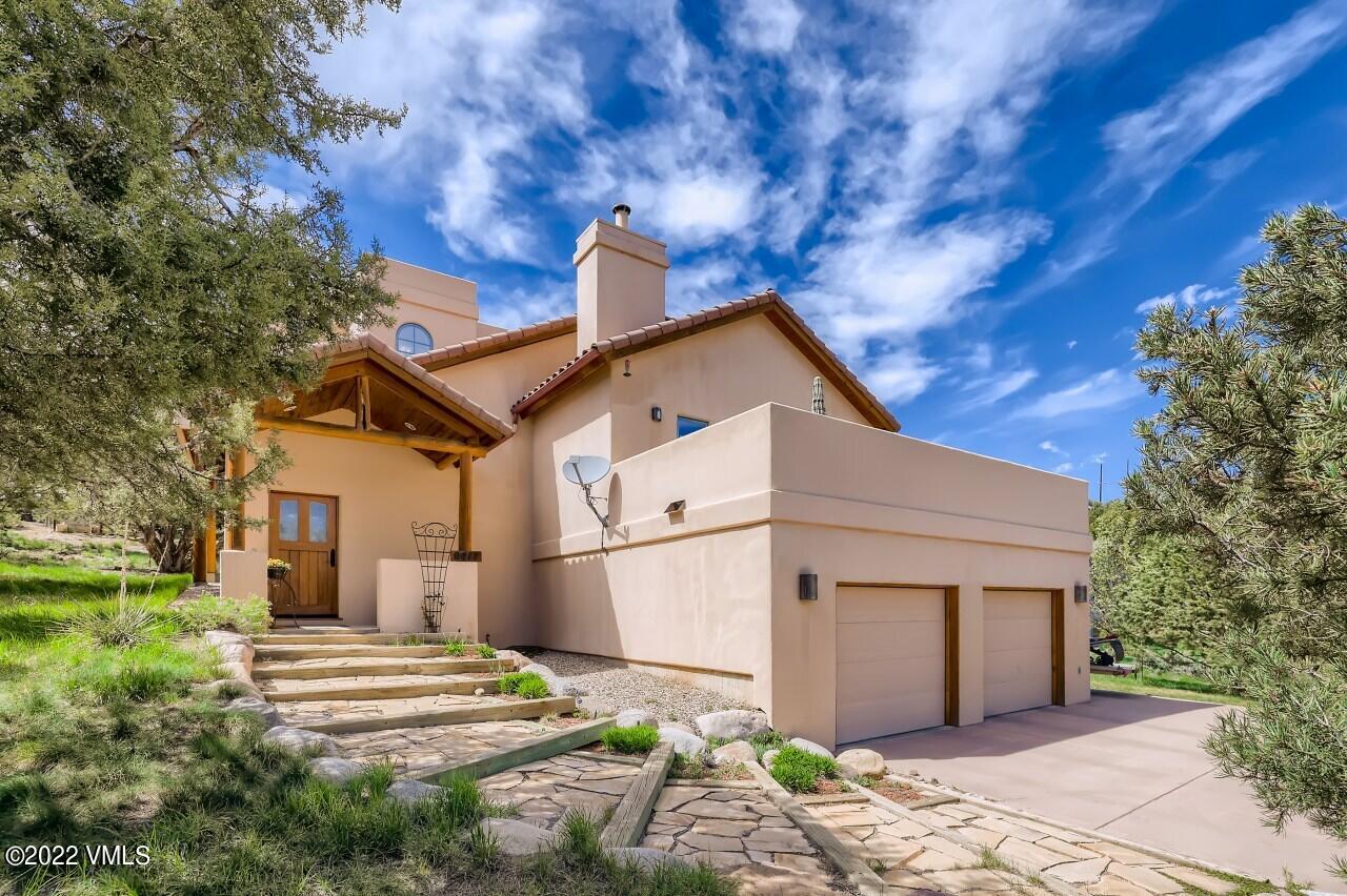 417 Neilson Gulch Road Eagle, CO 81631 - Photo 1 of 28 a front view of a house with a garden