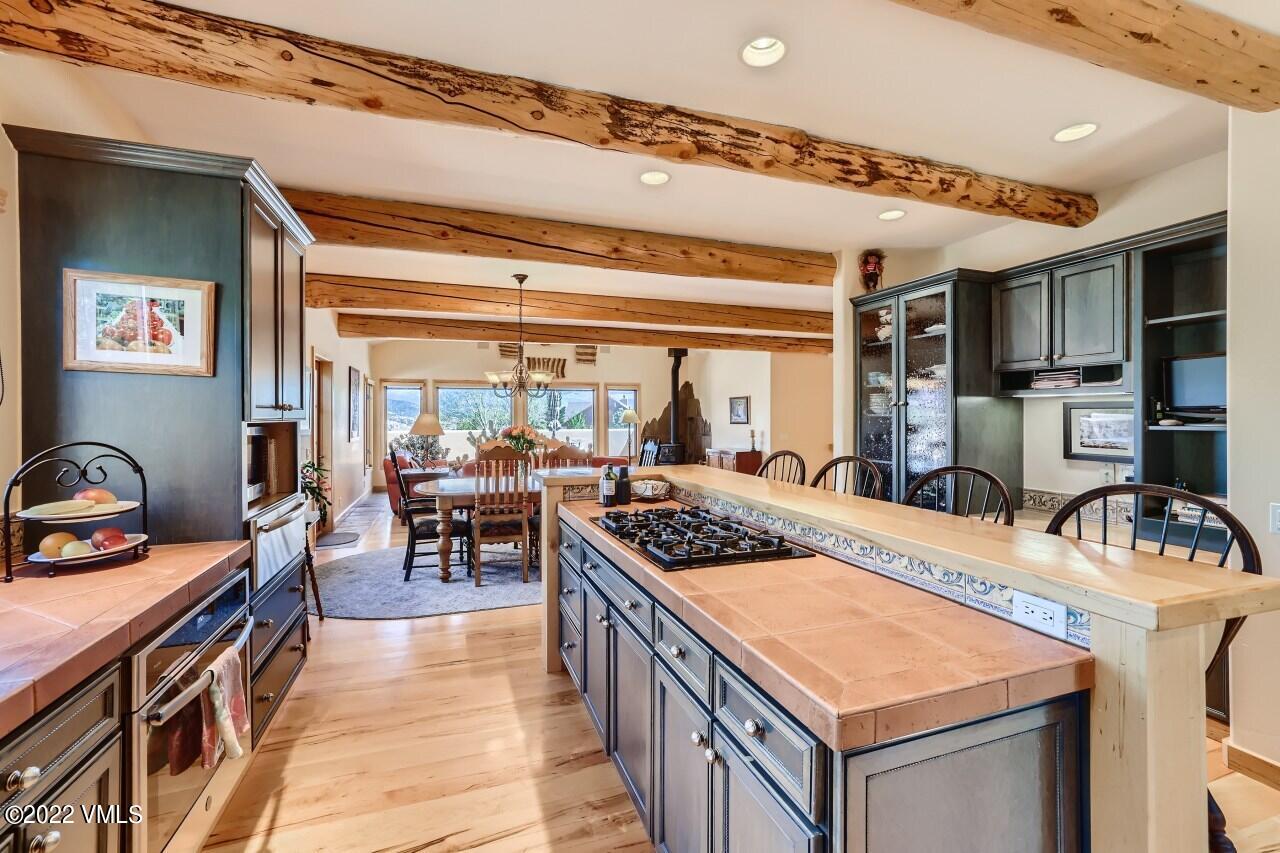 417 Neilson Gulch Road Eagle, CO 81631 - Photo 11 of 28 a kitchen with a stove top oven a sink a counter top space and living room view