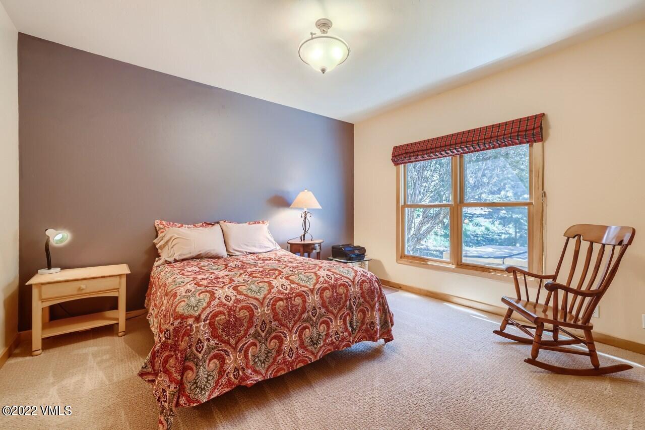417 Neilson Gulch Road Eagle, CO 81631 - Photo 12 of 28 a bedroom with a bed chair and window