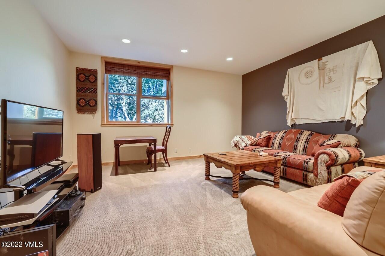 417 Neilson Gulch Road Eagle, CO 81631 - Photo 20 of 28 a living room with furniture a flat screen tv and a fireplace