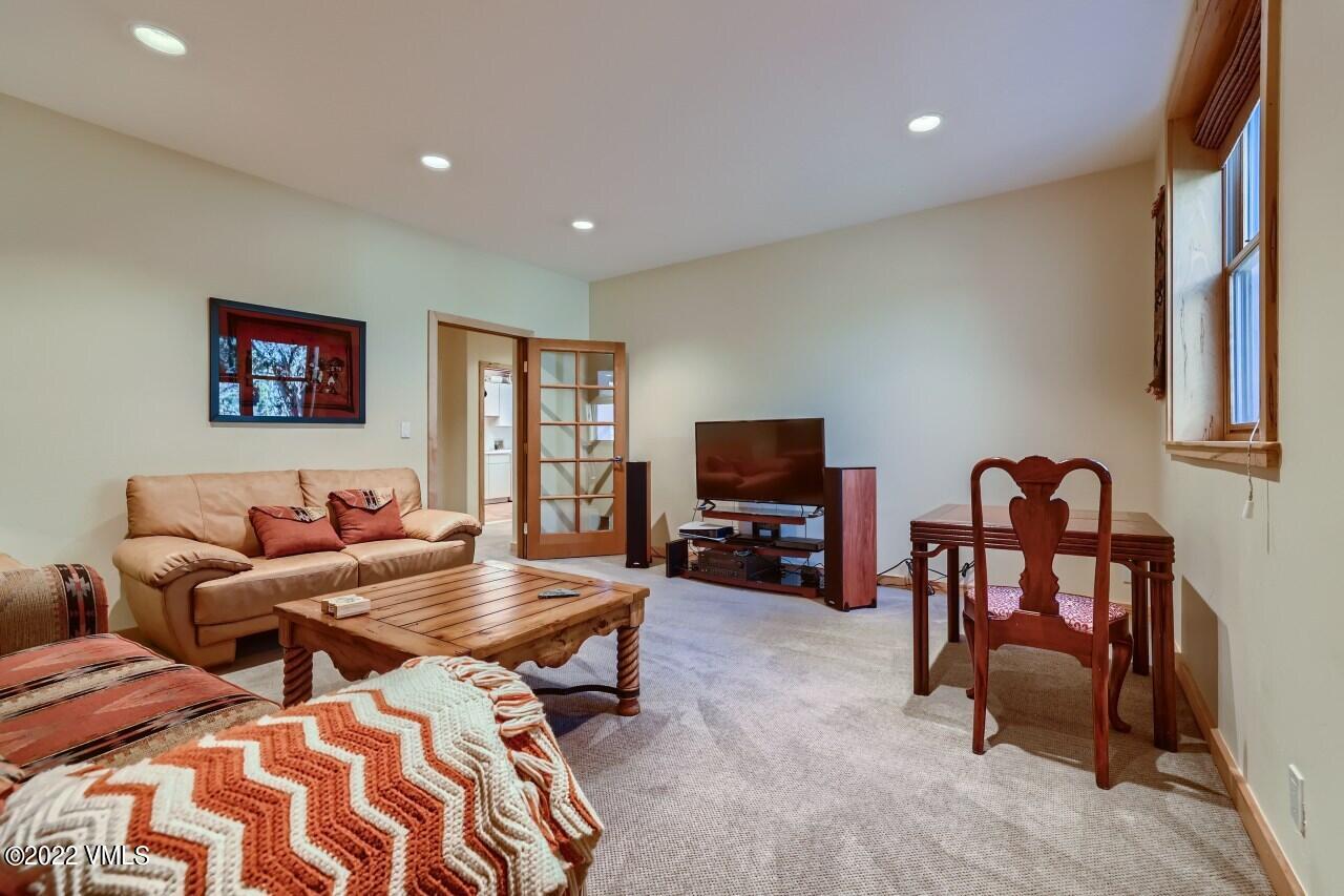 417 Neilson Gulch Road Eagle, CO 81631 - Photo 21 of 28 a living room with furniture and a flat screen tv