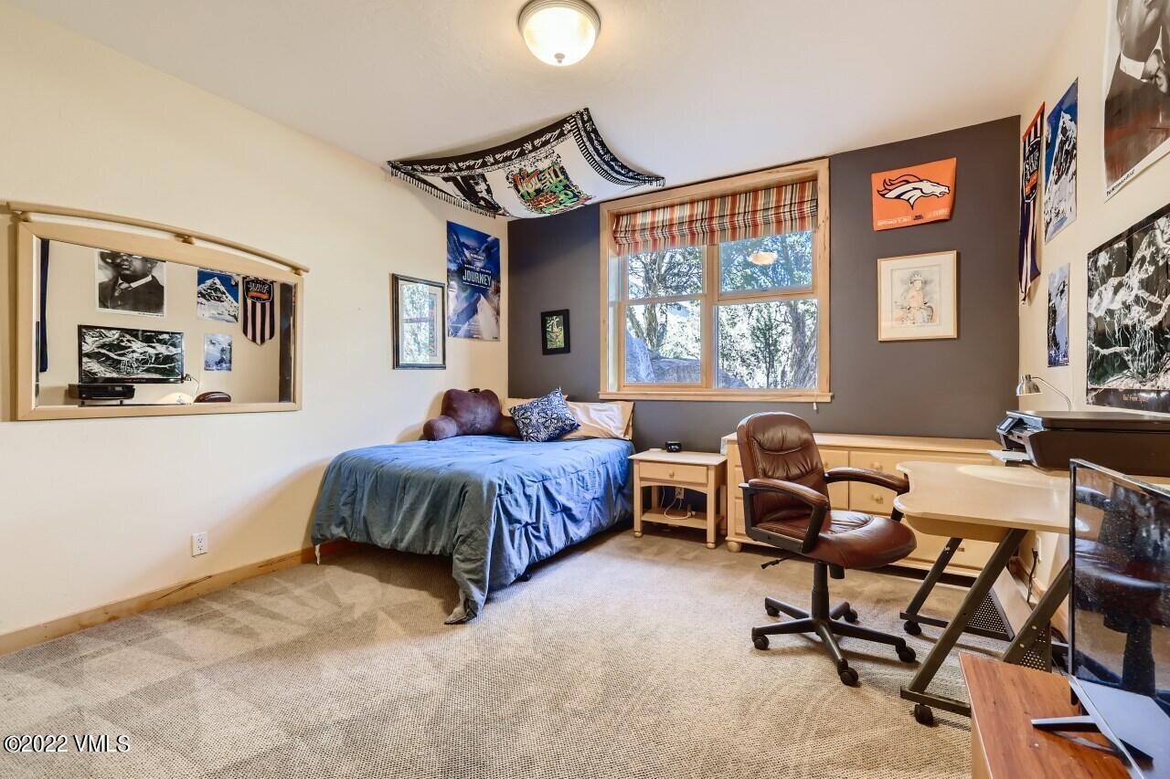 417 Neilson Gulch Road Eagle, CO 81631 - Photo 22 of 28 a spacious bedroom with a bed and a large window