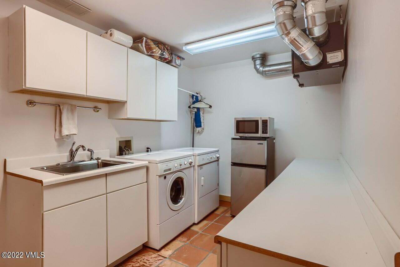 417 Neilson Gulch Road Eagle, CO 81631 - Photo 25 of 28 a kitchen with stainless steel appliances white cabinets and a sink