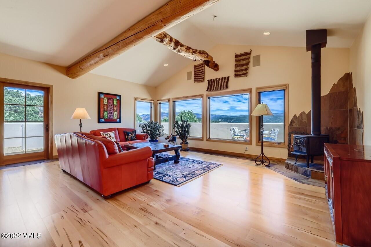 417 Neilson Gulch Road Eagle, CO 81631 - Photo 6 of 28 a living room with fireplace furniture and a flat screen tv