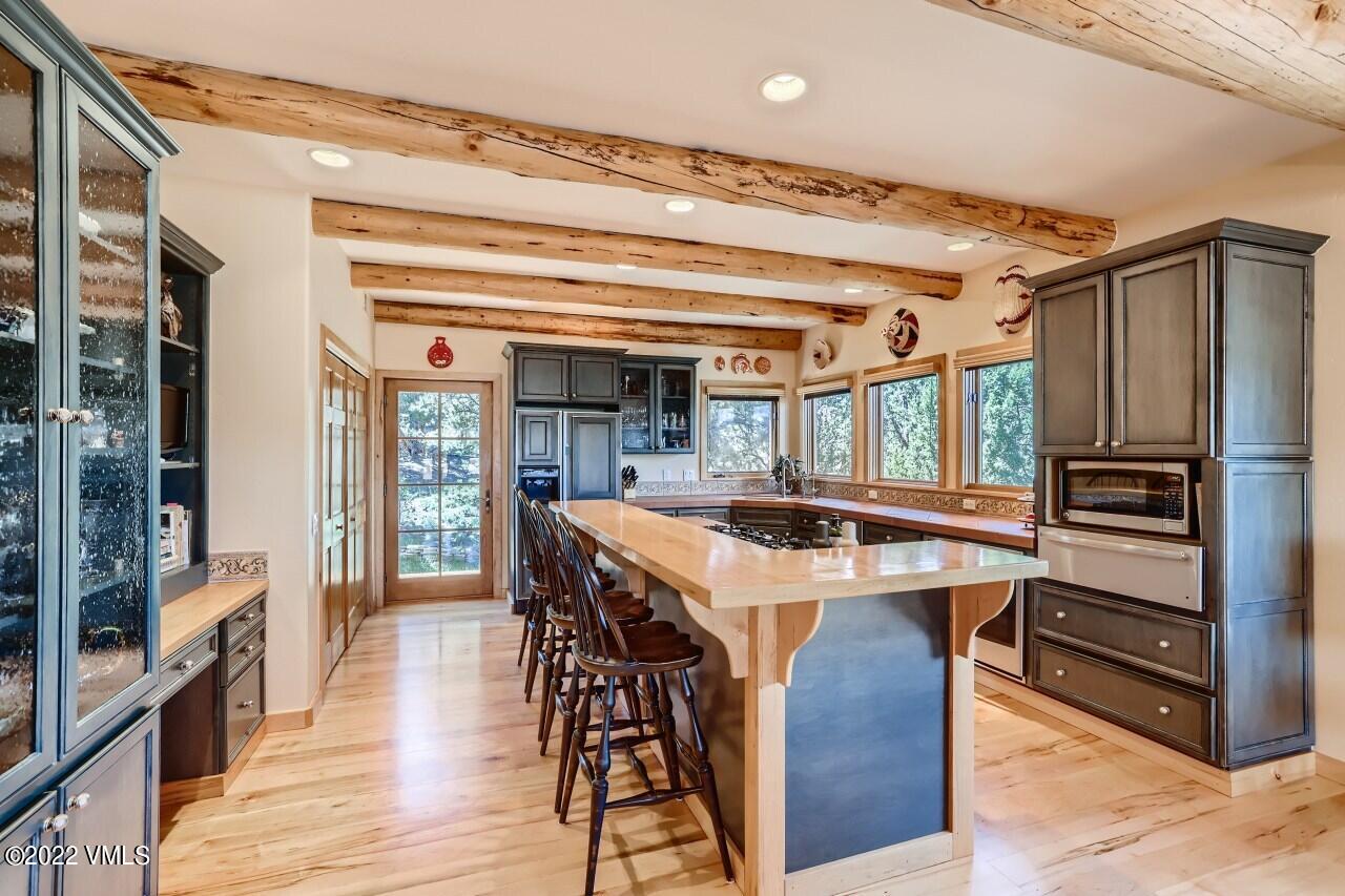 417 Neilson Gulch Road Eagle, CO 81631 - Photo 9 of 28 a kitchen with a stove a refrigerator and a stove top oven