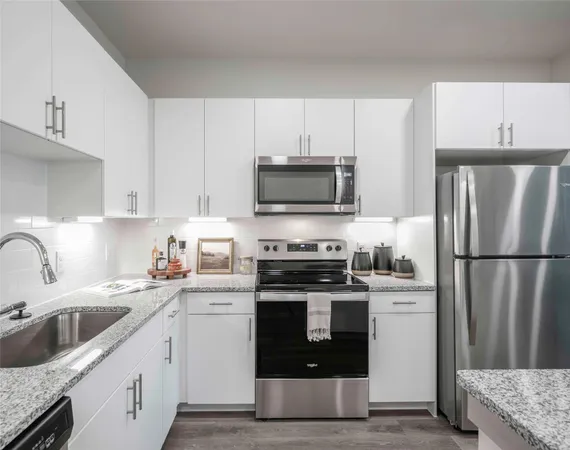 a kitchen with a sink white stove and refrigerator
