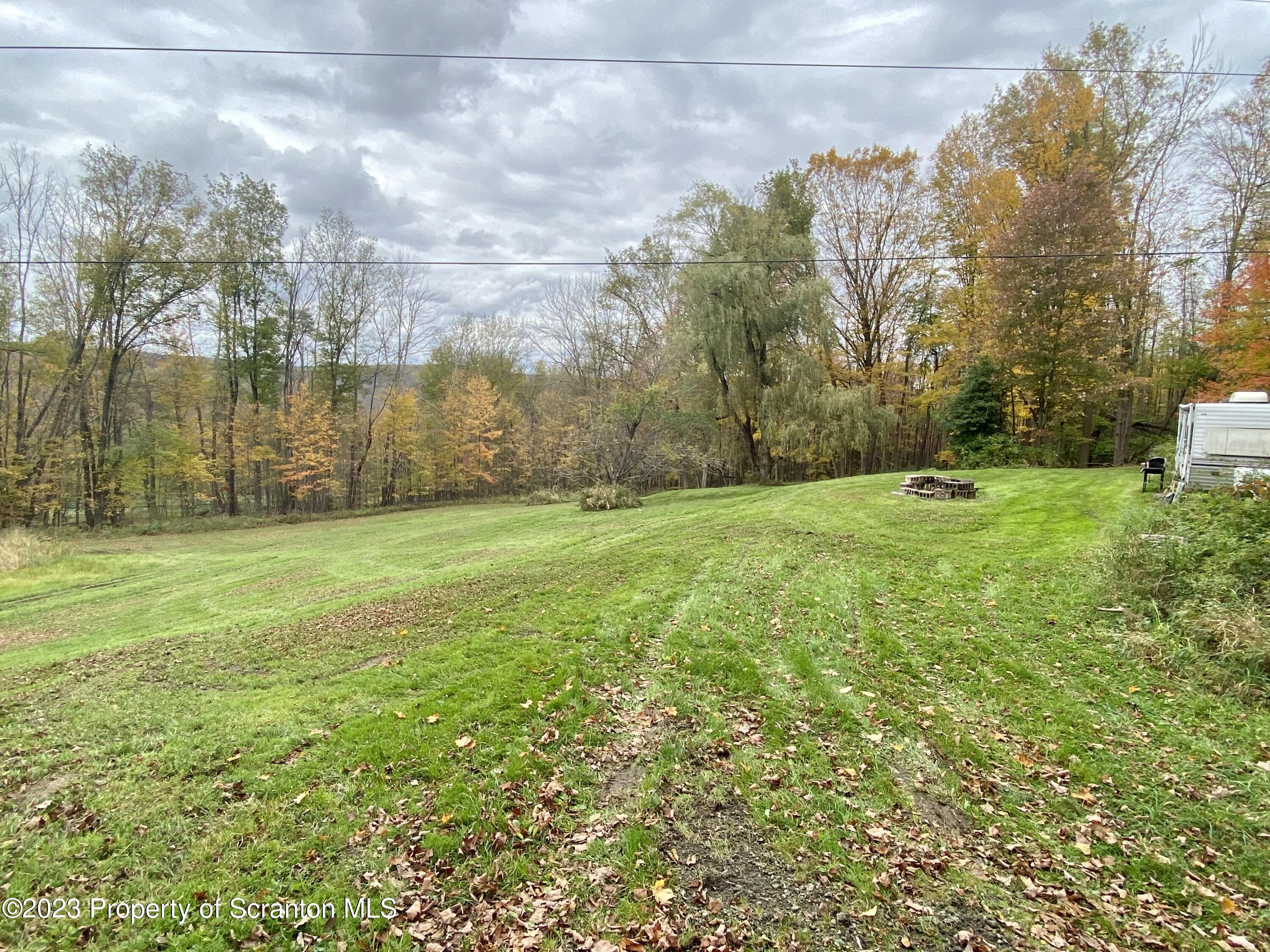 65 Powell Road Union Dale, PA 18470 - Photo 3 of 20 a backyard of apartments with large trees