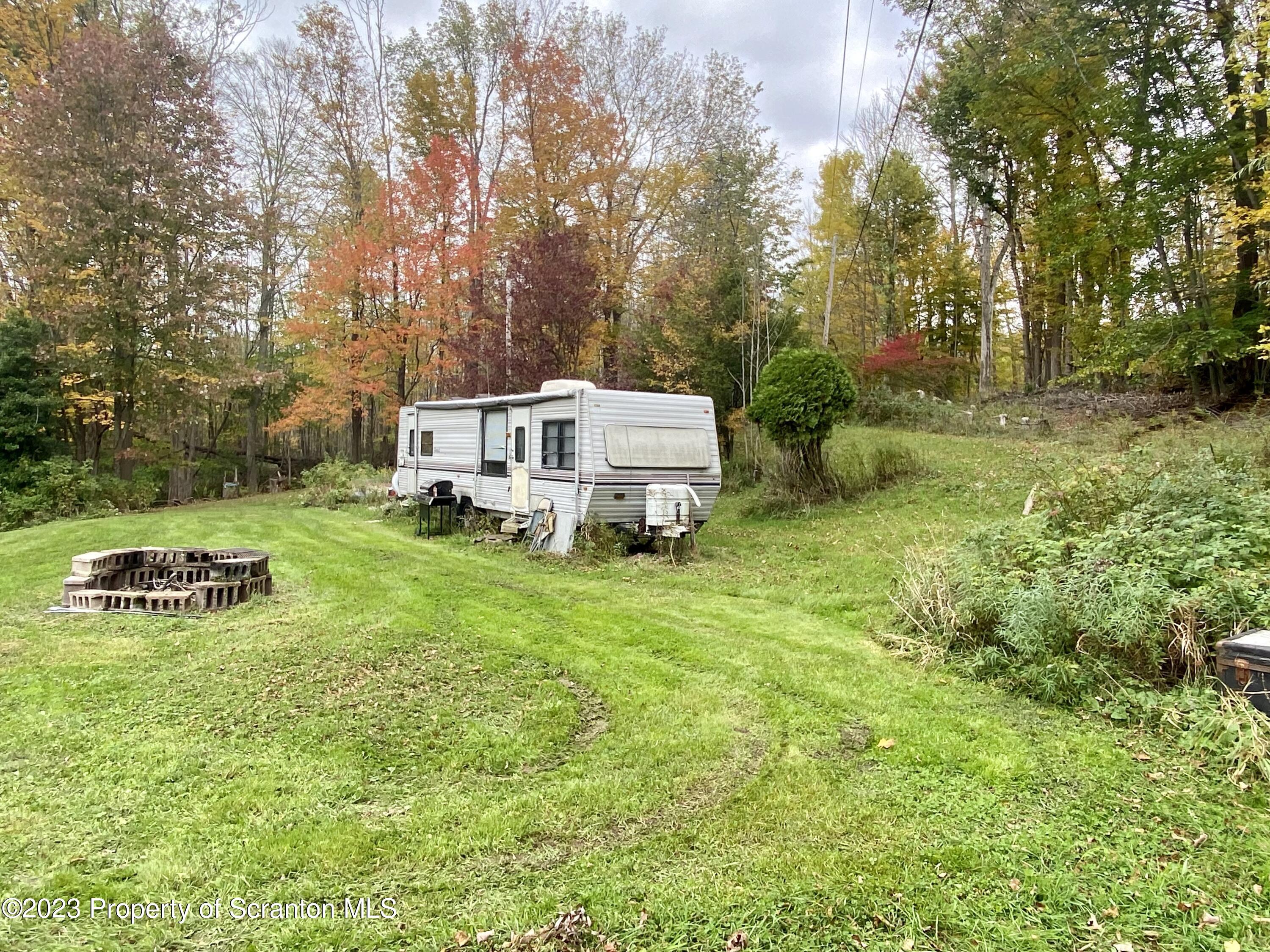 65 Powell Road Union Dale, PA 18470 - Photo 5 of 20 a view of a house with a yard and sitting area