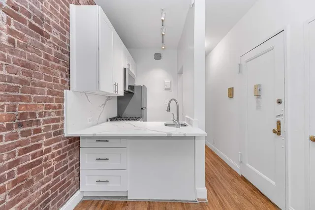 a kitchen with a sink a stove and cabinets