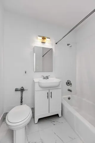 a bathroom with a sink a toilet and bathtub