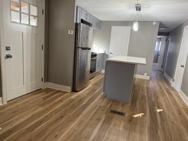 a kitchen with a sink and refrigerator