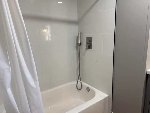 a white bath tub sitting in a shower