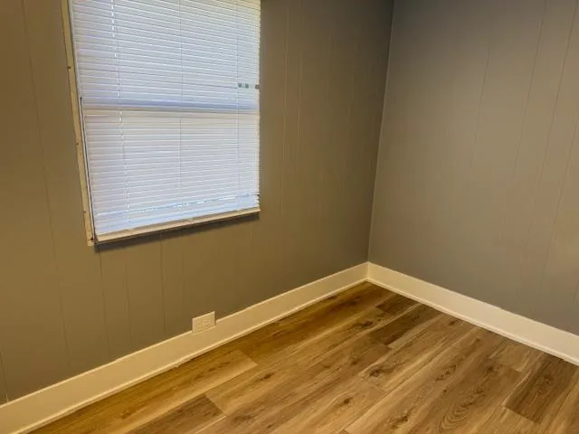 a view of a room with a wooden floor and a window