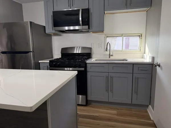 a kitchen with a sink and a refrigerator