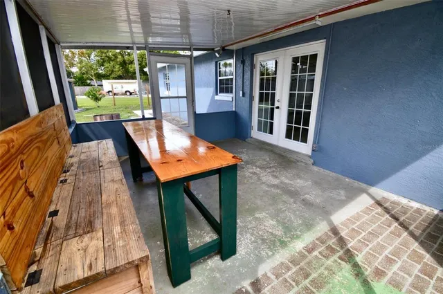 a view of a room with a large window and an outdoor view